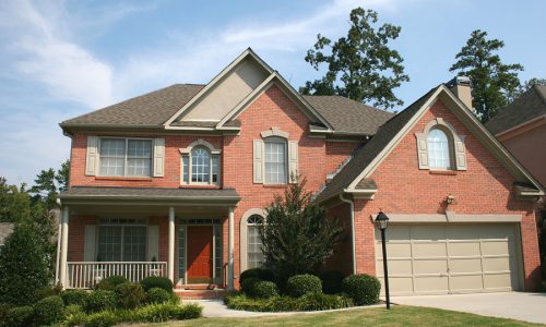 a nice brick house and blue sky