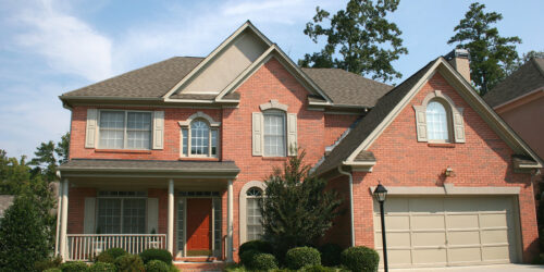a nice brick house and blue sky