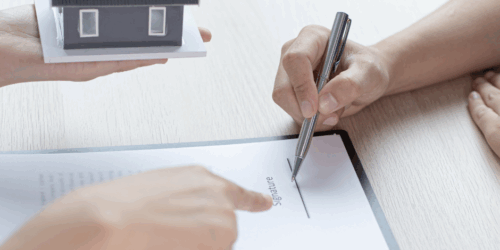Agressive Abusive Tenants big challenge for landlords. Picture of person signing a document.